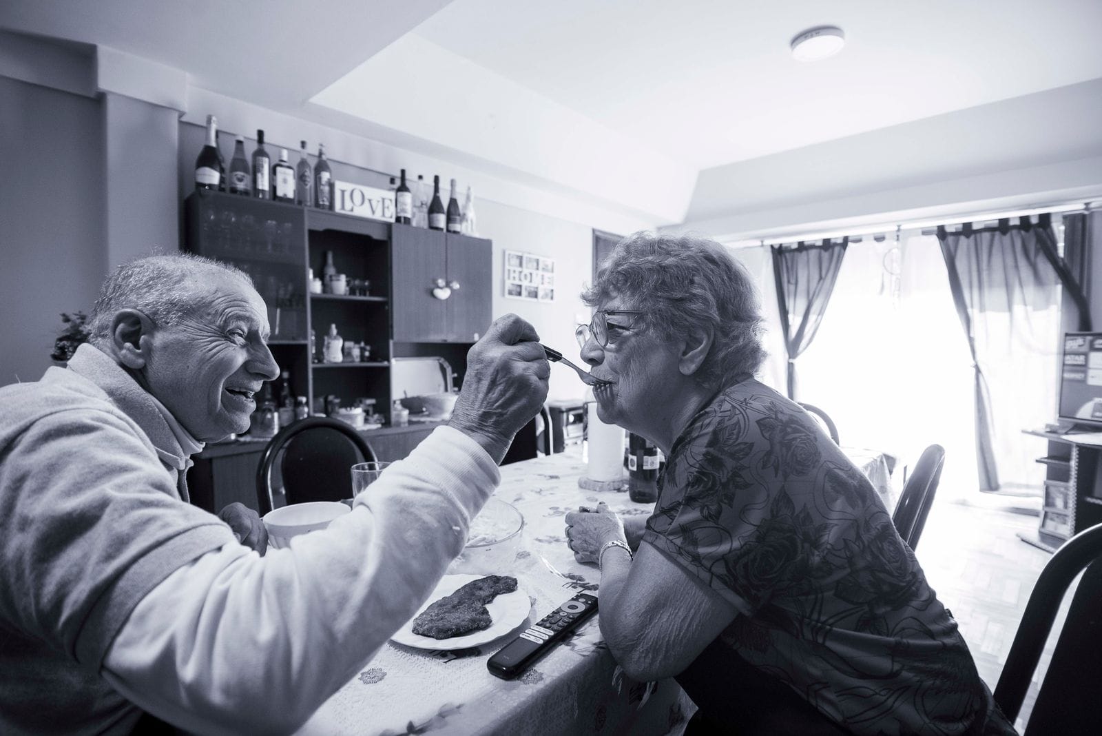 Elderly couple sharing a meal at home