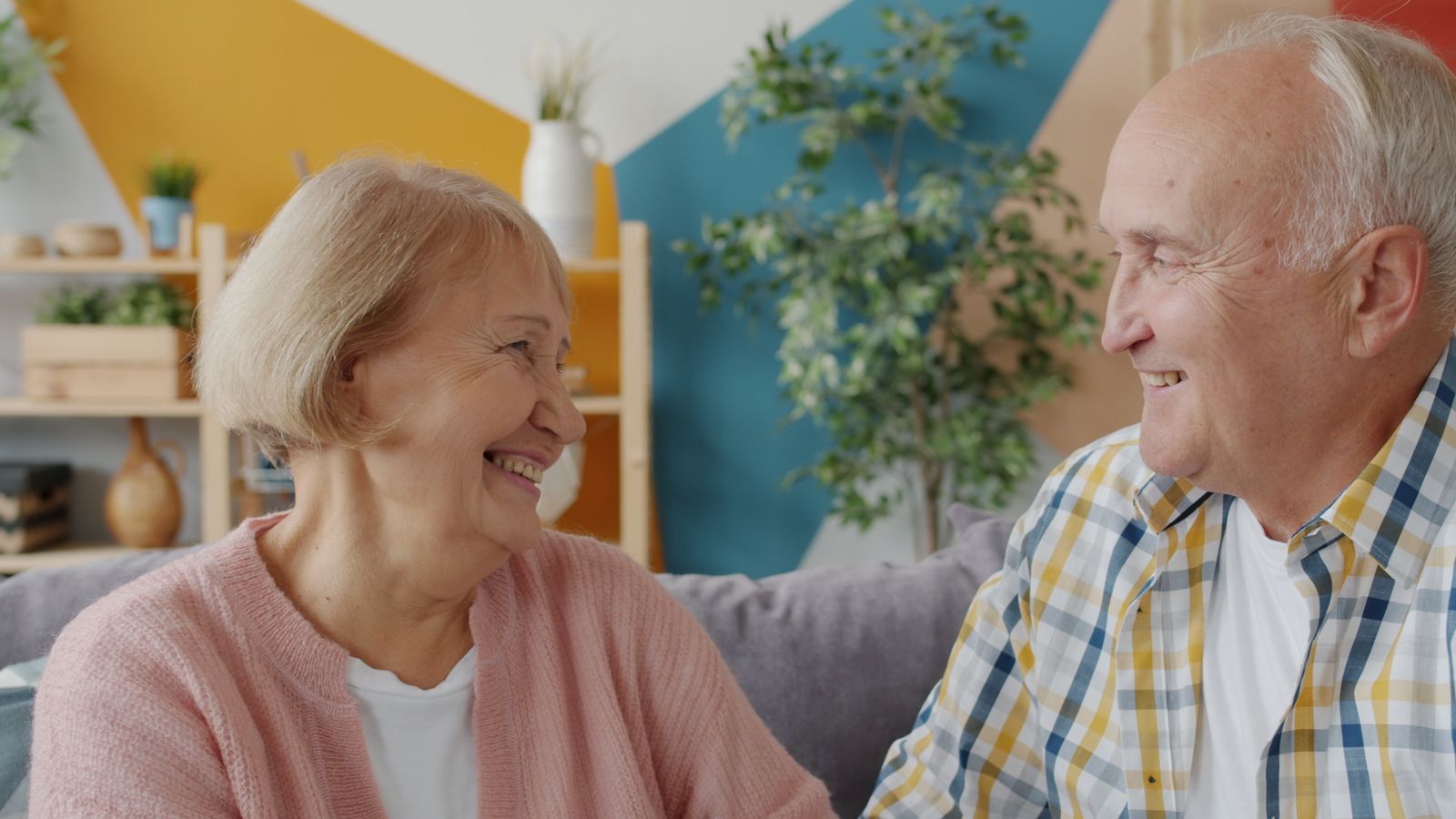 Happy senior couple laughing together at home