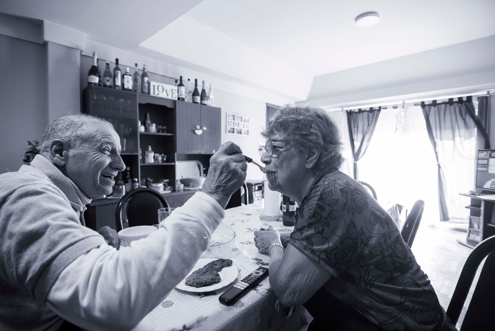 Elderly couple sharing a meal at home
